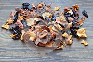 Various dried fruit displayed on an old wooden table.