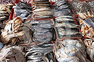 Various dried and salted fish, in several baskets, preserved food.