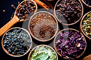 Various dried tea leaves in wooden bowl