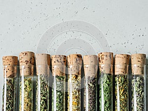 Various dry healthy herbs, plant flowers for brewing herbal tea in glass test tubes