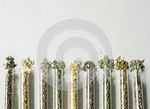 Various dry healthy herbs, plant flowers for brewing herbal tea in glass test tubes