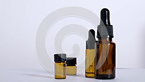 Various empty bottles of essential oils on a white background.