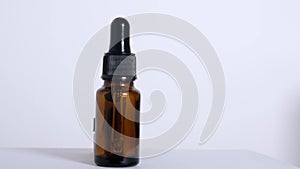 Various empty bottles of essential oils on a white background.