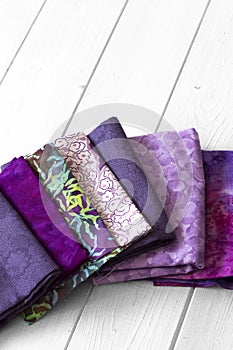 Various fabric material sample swatches,  with a purple theme