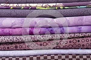 Various fabric material sample swatches,  with a purple theme