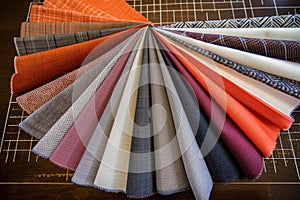 various fabric swatches fanned out on tailors work surface