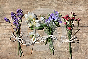Various flowers on the wooden table