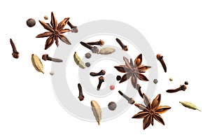 various flying spices for making masala tea isolated on white