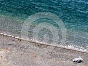 Various footprints left in the sand by sea water`s edge. Time , eternity concept.