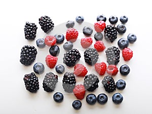 Various fresh berries isolated on white background. Raspberry, Blueberry, Blackberry.