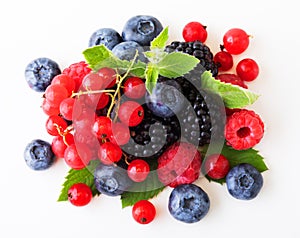 Various fresh berries isolated on white background. Raspberry, Blueberry, Cranberry, Blackberry and Mint leaves