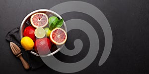 Various fresh citrus fruits in colander. Bood orange, lime, lemon