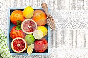 Various fresh citrus fruits in wooden box