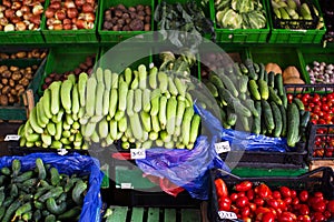 Various fresh fruits and vegetables in boxes on the shelves of the store, at the vegetable market.