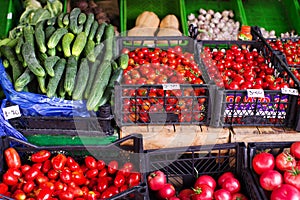 Various fresh fruits and vegetables in boxes on the shelves of the store, at the vegetable market.