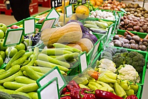 Various fresh fruits and vegetables in boxes on the shelves of the store, at the vegetable market.