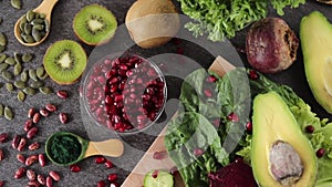 Various fresh fruits and vegetables in green and red color on a kitchen table