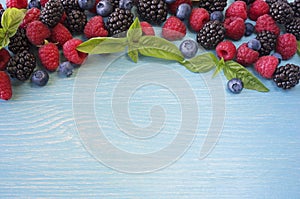 Various fresh summer berries on wooden background.