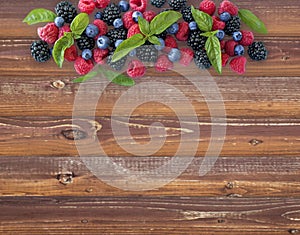 Various fresh summer berries on wooden background