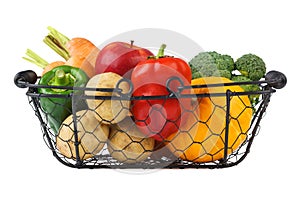 Various fresh vegetables and fruits in a wire basket. Isolated