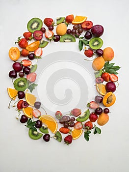Various fruits frame on white background. Different berries and fruits on white background. Copy space.