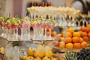 Various fruits and fruit desserts on a buffet table