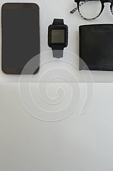 Various gadgets, spectacles and wallet on white background