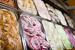 Various Gelato in a store window. Multicolor Ice cream rack in a snack bar