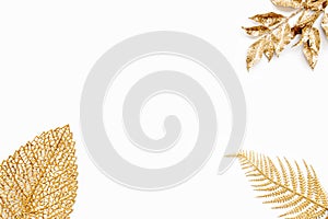 Various golden leaves over white background. Copy space
