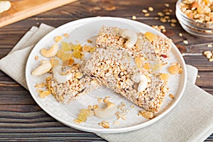 Various granola bars on table background. Cereal granola bars. Superfood breakfast bars with oats, nuts and berries