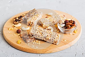 Various granola bars on table background. Cereal granola bars. Superfood breakfast bars with oats, nuts and berries