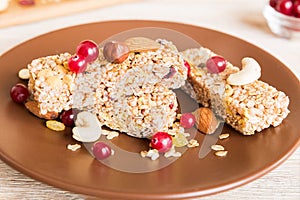 Various granola bars on table background. Cereal granola bars. Superfood breakfast bars with oats, nuts and berries