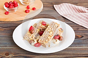 Various granola bars on table background. Cereal granola bars. Superfood breakfast bars with oats, nuts and berries