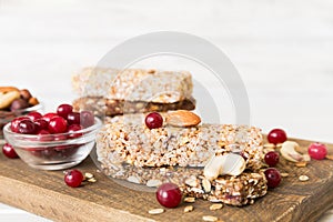 Various granola bars on table background. Cereal granola bars. Superfood breakfast bars with oats, nuts and berries