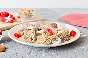 Various granola bars on table background. Cereal granola bars. Superfood breakfast bars with oats, nuts and berries