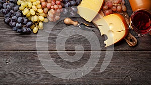 Various grapes, glass of wine and cheese