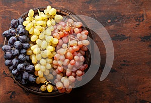 Various grapes on old wooden barrel