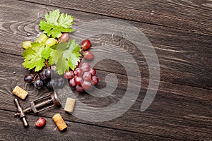 Various grapes, wine corks and corkscrew