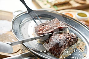 Various grilled meat set with Pickled cabbage and two sauces. Serving on a wooden Board. Barbecue restaurant menu, a