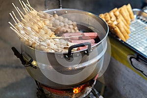 Various grilled meats for sale at night walking market in Northern Thailand