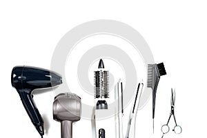 Various hair styling devices on white background, top view