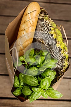 Various healthy food in paper bag on wooden background. Healthy food from the store