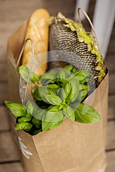 Various healthy food in paper bag on wooden background. Healthy food from the store