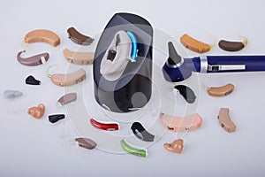Various hearing aids on white background,
