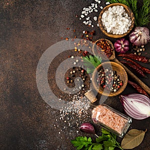 various herbs and spices on dark background.