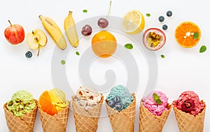 Various of ice cream flavor in cones blueberry ,strawberry ,pistachio ,almond ,orange and cherry setup on white wooden background