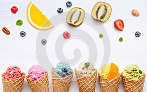 Various of ice cream flavor in cones blueberry ,strawberry ,pistachio ,almond ,orange and cherry setup on white wooden background