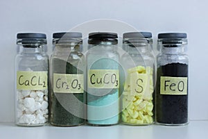 Various inorganic mineral chemicals in glass jars. photo