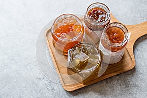 Various Jar of Fruit Jams Fig, Quince, Bergamot Citrus, Watermelon on Wooden Tray / Marmalade.