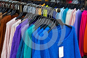 Various jumpers and cardigans on hangers